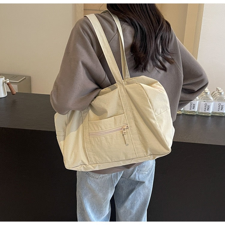 Girl carrying beige STOKADO aesthetic nylon pouch bag