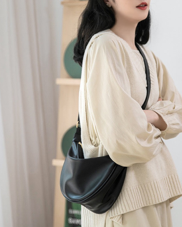 Model wearing STOKADO black crescent bag over the shoulder