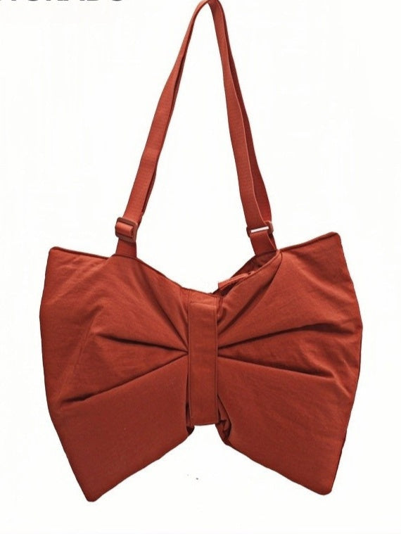 STOKADO oversized tote with a statement bow design in burnt orange, perfect for daily styling.