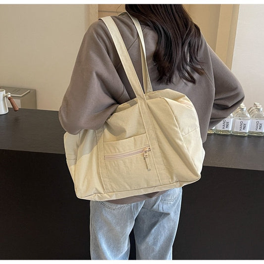 Girl carrying beige STOKADO aesthetic nylon pouch bag