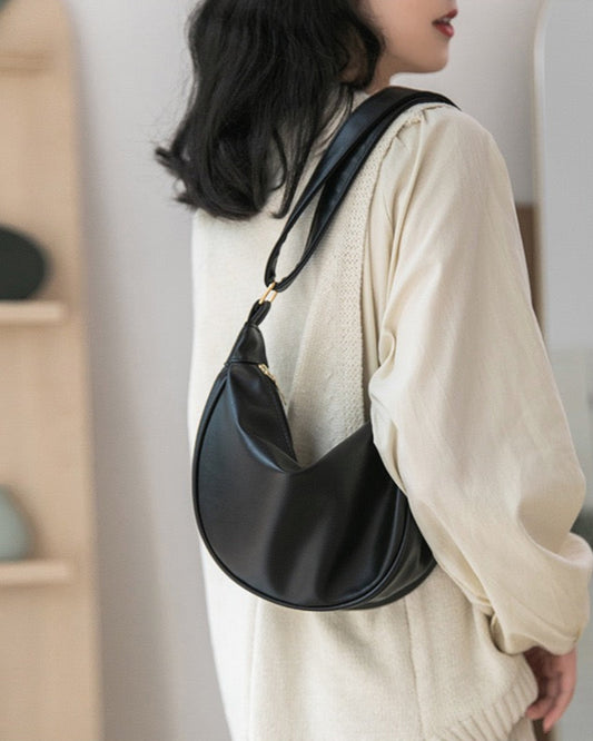 STOKADO crescent shoulder bag in black vegan leather with minimalist crossbody strap