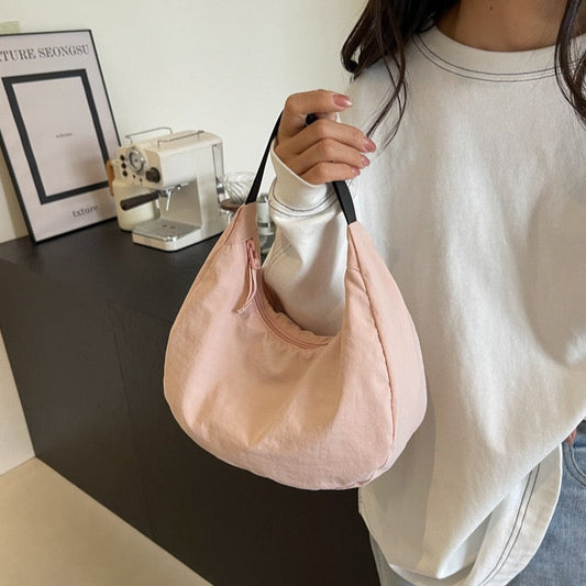 Model wearing STOKADO pink mini nylon shoulder bag