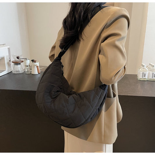 Model wearing black STOKADO quilted nylon crossbody bag